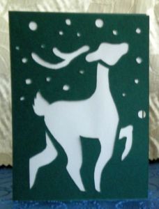 Handmade greeting card with a reindeer in snow